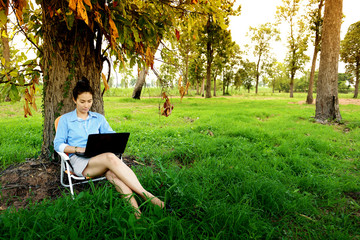 Business woman using laptop in the field