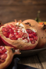 Pomegranate fruit on rustic table