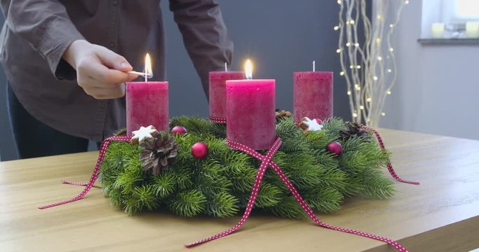 Second Sunday of Advent - a young woman is lighting the second candle of the advent wreath - ProRes
