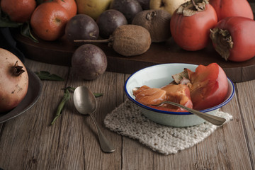 Persimmon fruit on rustic table