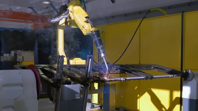 Metal iron laser argon welding on industrial CNC machine in factory. Automation of work. Modern technologies.