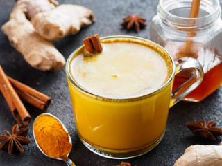 golden turmeric latte and ingredients, copy space