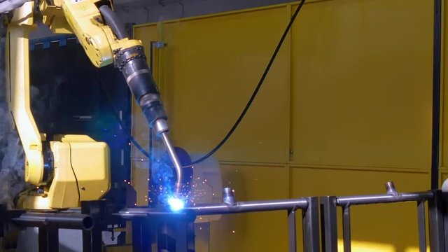 Metal iron laser argon welding on industrial CNC machine in factory. Automation of work. Modern technologies.