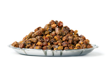 Propolis granules inside plate, bee product