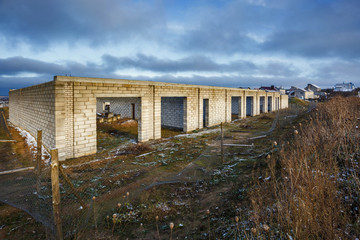 Fototapeta na wymiar abandoned unfinished garages without a roof with slush and swamp.place of gathering stalkers
