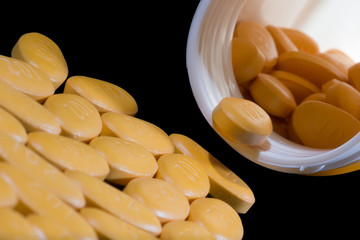 Medicine tablets (or pills) spilling out from the bottle