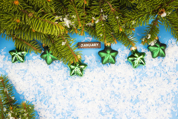 Christmas tree on wooden background with decorations, snow and the words of December