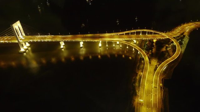 Illuminiated Sai Van Bridge and Highway Stack Interchange in Macau at Night from above.