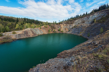 Fototapeta na wymiar Blue lake in Altai. This is a former copper mine that was flooded with water