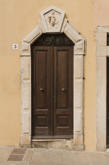 Wooden door with marble decorations