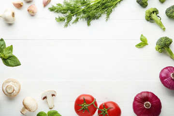 Fototapeta na wymiar Frame of variety vegetables on white wooden table