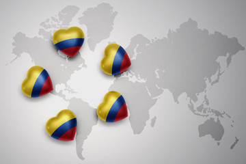 five hearts with national flag of colombia on a world map background