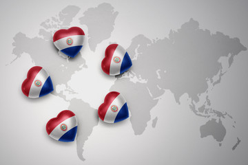 five hearts with national flag of paraguay on a world map background