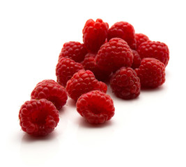 Red raspberries isolated on white background fresh heap.