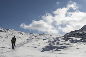 Fototapeta na wymiar Boy hiking no a snowy trail