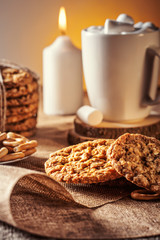 Winter autumn still life  homemade recipe honey ginger oatmeal cookie and bagel, cocoa cup coffee with marshmallow on wooden table kitchen