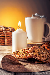 Winter autumn still life  homemade recipe honey ginger oatmeal cookie and bagel, cocoa cup coffee with marshmallow on wooden table kitchen