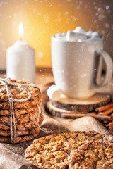 Winter autumn still life  homemade recipe honey ginger oatmeal cookie and bagel, cocoa cup coffee with marshmallow on wooden table kitchen
