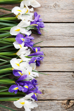 Bouquet of iris flowers on grey wooden table