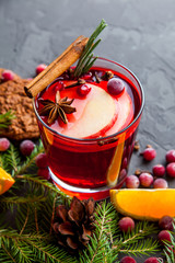 Winter cocktail grog, hot sangria, mulled wine. On dark table. 