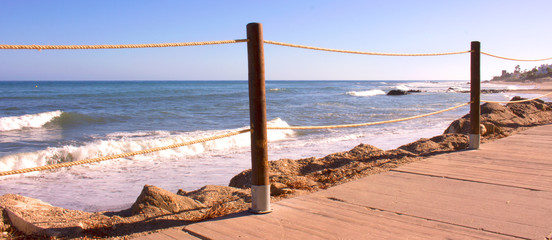 Obraz premium Beach. Wooden road in the beach. Costa del Sol, Andalusia, Spain.