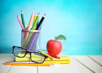 Back to school concept.Education supplies empty blue background.