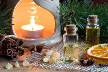 Selection of essential oils with star anise, cinnamon, frankincense, clove, dried orange