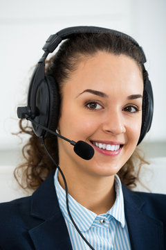 Young woman call center operator talking with client