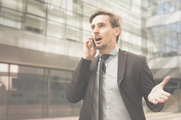 Young male in jacket talking on the phone