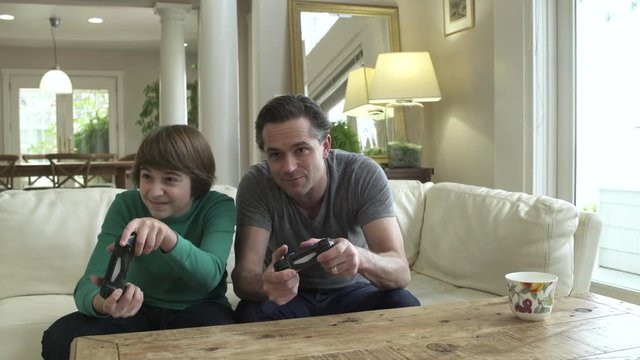 Father and son playing video game together