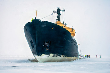 giant black ice breaker ship,in the ice cold water of the north ocean