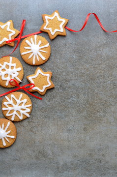 Festive cookies on stone background with red ribbon