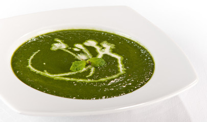 green spinash soup with cream in a plate