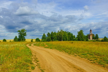 country road before the rain church in the distance dark sky