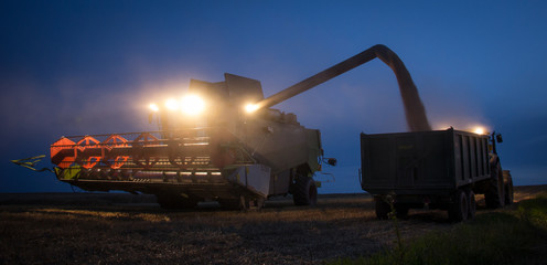 combine harvester unloading grain