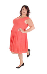 A plus size woman standing in a red dress