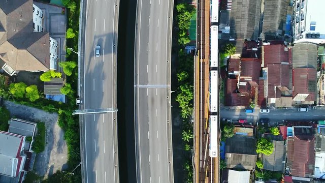 Moving cars, motorcycles and train as view from above.