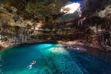 Cenote Samula Dzitnup near Valladolid, Yucatan, Mexico - swimming in crystal blue water - obrazy, fototapety, plakaty