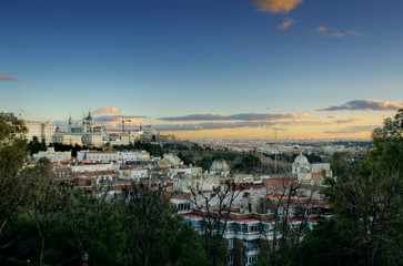 Panoramic view of Madrid cityscape with the Royal Palace and Cathedral de la Almudena at the left side, taken from Debod's temple at sunset. HDR image.