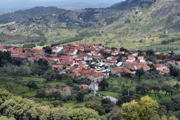 Naklejka na ściany i meble Top view of a Portuguese historic village. Houses surrounded by mountains and green vegetation.