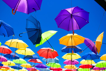 Multicolor umbrellas. Street art. Puerto Banus city, Marbella, Andalusia, Spain.