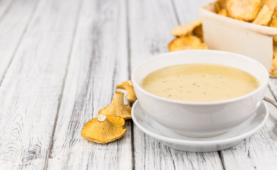 Fresh made Creamy Chanterelle Soup on a rustic background