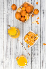 Wooden table with fresh made Tangerine Juice (close-up shot)