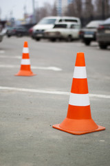 Car barriers orange and white on the road.