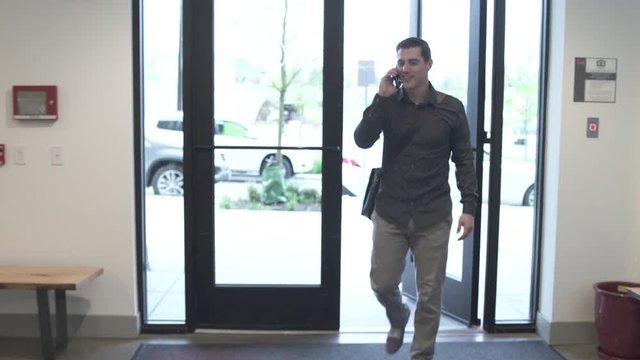 Tracking shot of a man taking the elevator