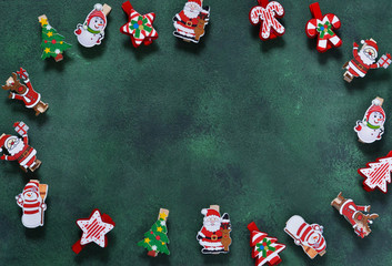 New Year green background with decorative clothespins. Happy New Year and Merry Christmas!