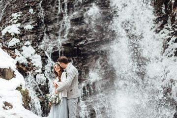 bride and groom on the mountain waterfall