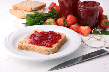 Fresh raspberry jam with toast or bread for breakfast.
