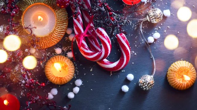 Christmas holiday background with decorations, candles, garland and candy cane. 4K UHD video 3840x2160