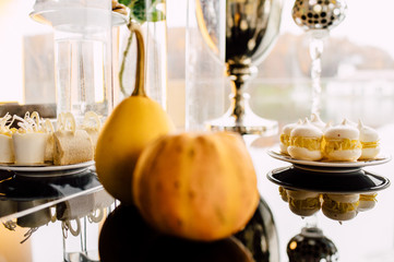 Wedding reception dessert table with delicious decorated white cupcakes with frosting closeup